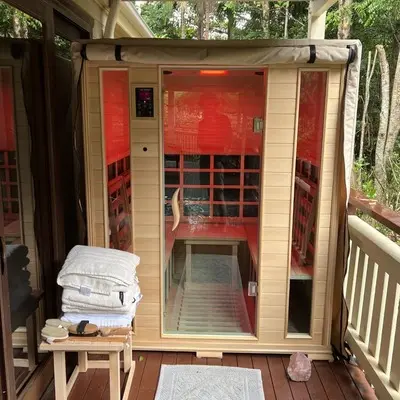 An infrared sauna with proper weatherproofing is placed outdoors in good condition.